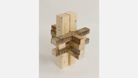 Verschachteltes Modell einer Holzverbindung aus neuem und gealtertem Holz, vor hellem Hintergrund.