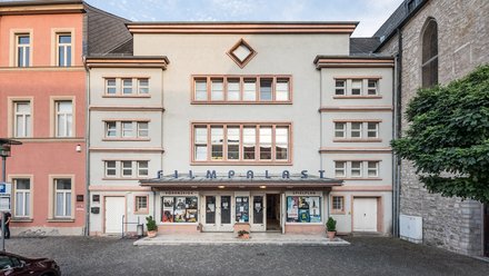Außenansicht eines Kinos mit symmetrischer Fassade.