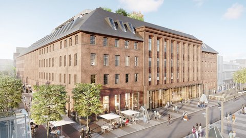 Historisches Backsteingebäude mit Erdgeschossnutzung und Menschen im öffentlichen Raum.