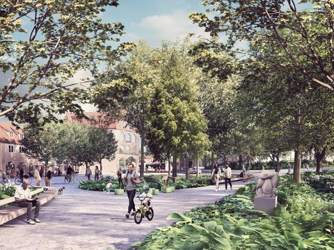 Öffentlicher Park mit breiter gepflasterter Wegebahn. Jogger in dunkler Kleidung läuft vorbei. Dichte Baumkronen rahmen den Weg ein. Rechts eine Skulptur, im Hintergrund historische Steingebäude. Grüne Wiese und Vegetation.