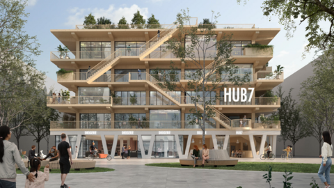 Modernes Gebäude mit Dachbegrünung und einigen Menschen, die spazieren gehen.