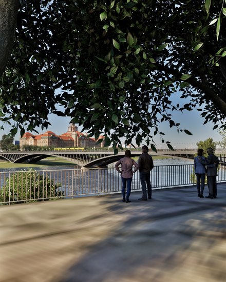 Eine Visualisierung zeigt einen begrünten Uferweg unter großen Bäumen mit Blick auf einen Fluss und eine moderne Brücke, mehrere Menschen bleiben stehen, lehnen am Geländer oder schauen gemeinsam auf das Wasser und die gegenüberliegende Stadtsilhouette, wodurch das Bild öffentlichen Raum am Wasser als Aufenthaltsort darstellt und für die Verbindung von Infrastruktur, Landschaft und sozialer Nutzung steht.
