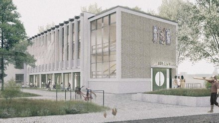 Außenansicht eines Gebäudes mit Werkstattnutzung und Grünumfeld.