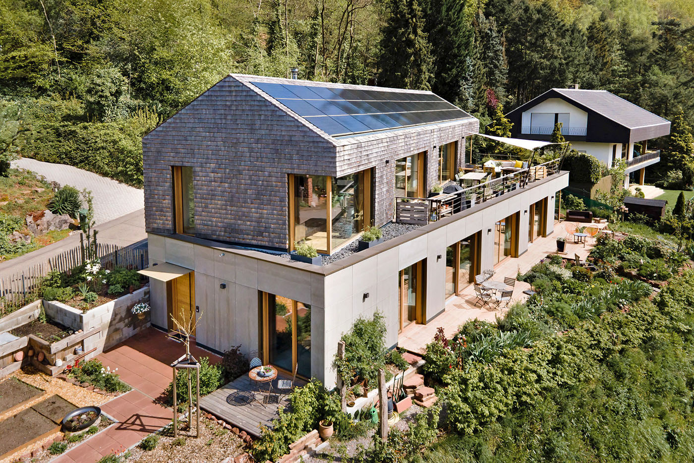 Einfamilienhaus am Hang mit Fassade aus Holzschindeln