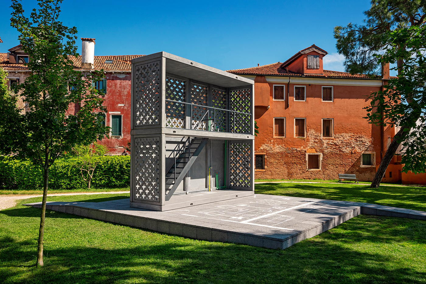 Offene Betonmodule mit Treppe auf einer grünen Wiese