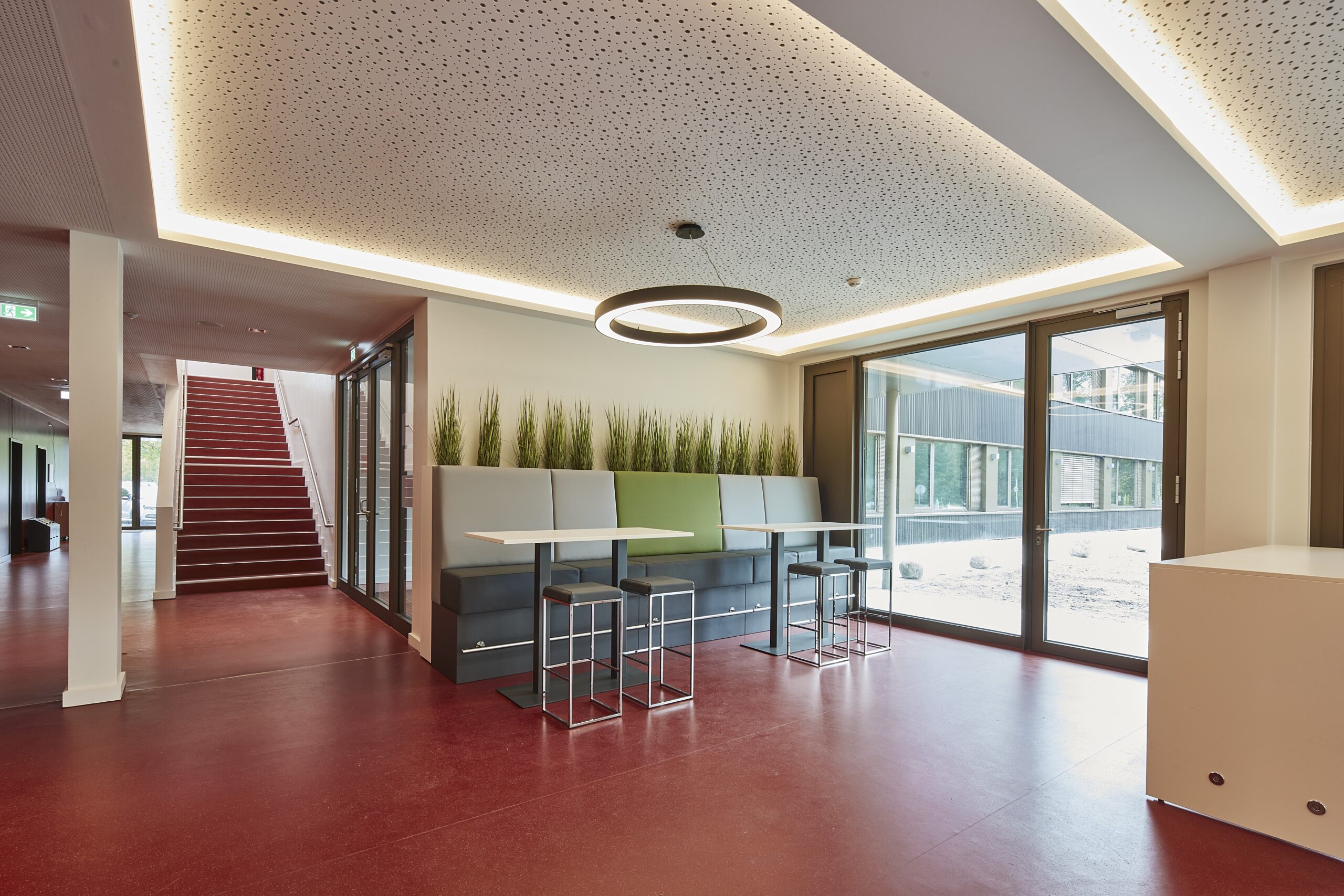 Flur in einem Schleswiger Schulgebäude mit Treppe und Sitzgelegenheiten